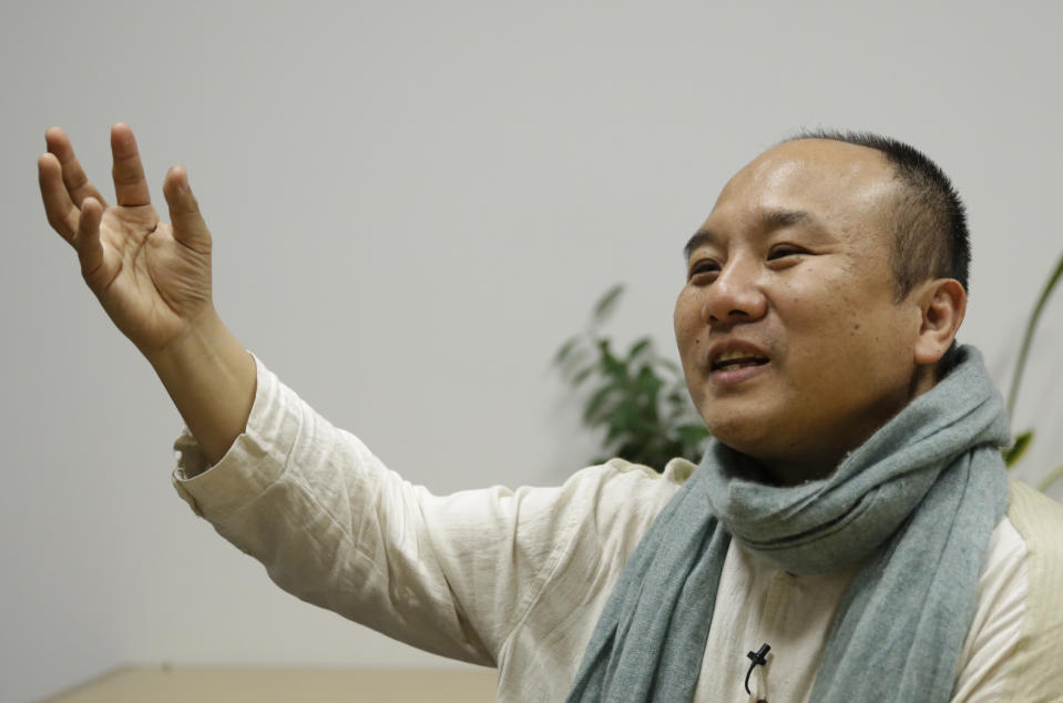 In this March 8, 2017 photo, Kazuo Sawato speaks during an interview in Tokyo. The 31-year-old Japanese office worker ran to the roof's edge and jumped. He landed on his legs, and initially regretted surviving. Now 42, Sawato says he is glad to be alive and wants to share his journey back to the world of the living with others who struggle under the societal pressure that make Japan one of the world's most suicide-prone societies. (AP Photo/Ken Moritsugu)