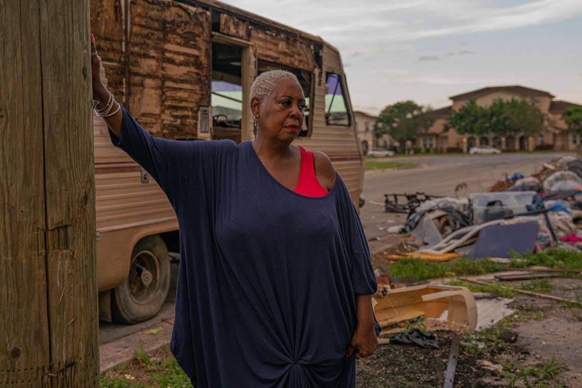 Resident Sonya Brown-Wilson poses for a portrait as she looks at the trash in the empty lot on Northwest 74th Street and Northwest 25th Avenue in Miami on Nov. 30, 2022.