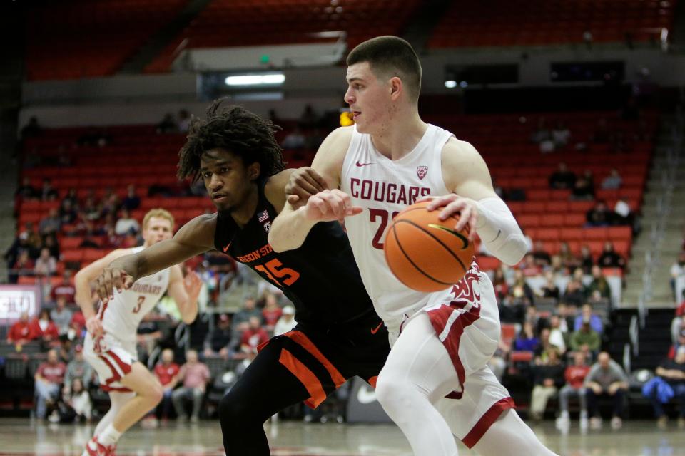 Washington State forward Andrej Jakimovski, right, drives while defended by Oregon State forward Glenn Taylor Jr. last season. The Cougars and Beavers, the only current members of the Pac-12 conference, are working on a deal to play West Coast Conference games in basketball and Olympic sports for the next two years.