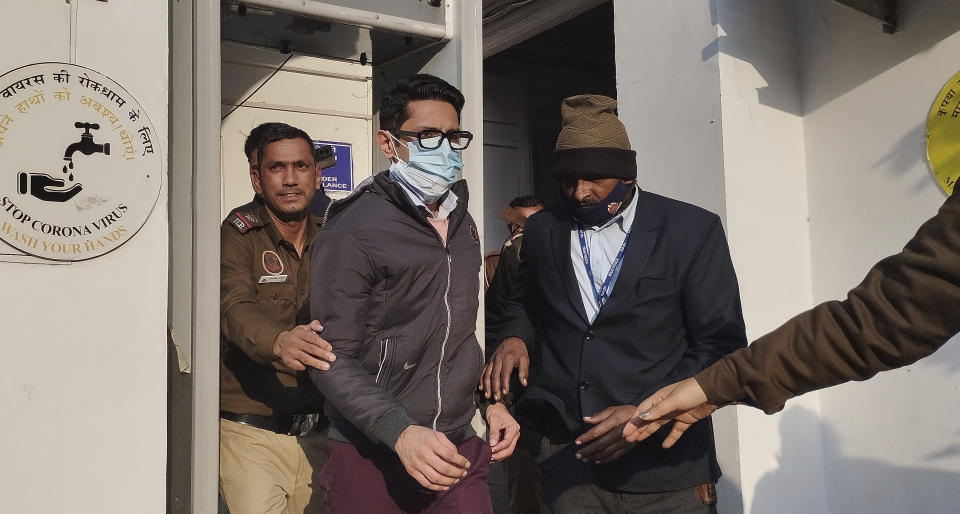 Policemen escort Shankar Mishra, arrested for being an unruly airline passenger, outside a court in New Delhi, Saturday, Jan. 7, 2023. Indian police arrested Mishra following a complaint by a woman aboard an Air India flight from New York that he urinated on her in business class. (AP Photo/Dinesh Joshi)