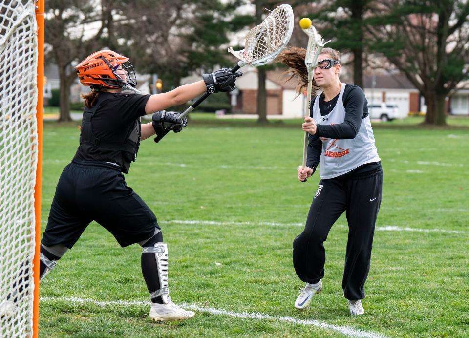 Pennsbury girls' lacrosse goalie Kema Brown defends the goal from an attack by Sasha Dobos as they practice for the upcoming 2024 season in Fairless Hills on Wednesday, March 20, 2024.