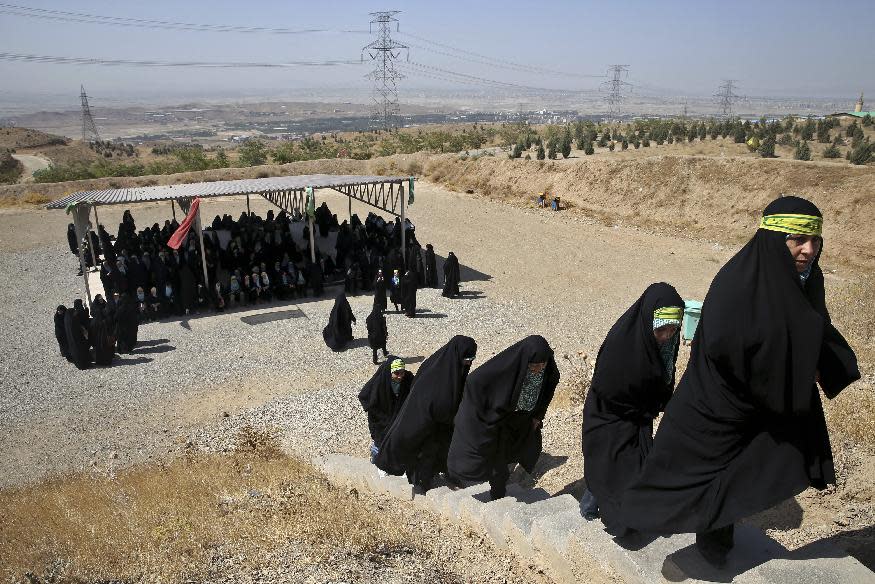 In this Thursday, Aug. 22, 2013 photo, female members of the Basij paramilitary militia attend a training session in Tehran, Iran. The Basij has its roots as volunteer fighters during the 1980-88 war with Iraq. It then developed as a grass-roots defender of the system _ taking on roles such as Islamic morality police at checkpoints and parks or as shock troops busting up pro-reform gatherings or publications. Precise numbers on Basij membership are not published, but some estimates range as high as 1 million or more.(AP Photo/Ebrahim Noroozi)