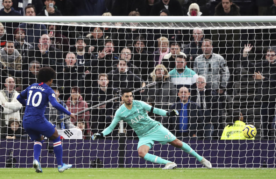 Chelsea's Willian scores his side's second goal of the game from the penalty spot during the English Premier League soccer match against Tottenham, at the Tottenham Hotspur Stadium, London, Sunday, Dec. 22, 2019. (Nick Potts/PA via AP)