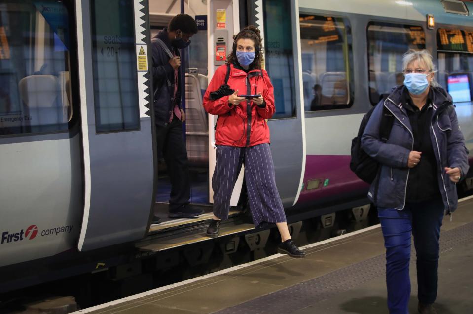 Commuters at Leeds railway station (PA)