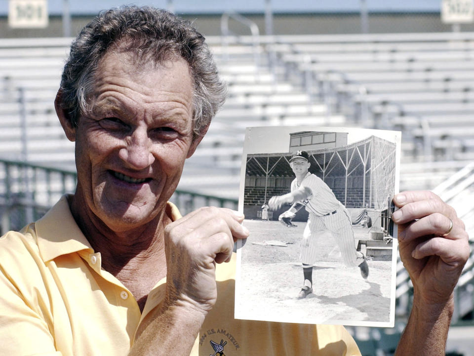 Former major league pitcher Jim Kaat poses with a photo of himself at age 19 before a spring training baseball game between the Houston Astros and the Florida Marlins in Jupiter, Fla., March 22, 2004. Minnesota Twins broadcaster Kaat referred to New York Yankees left-hander Nestor Cortes by an offensive nickname during a broadcast Thursday, June 2, 2022, the second offensive remark in the past year by the 83-year-old Hall of Fame pitcher while calling a game. (AP Photo/James A. Finley, File)