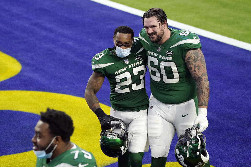 New York Jets cornerback Arthur Maulet (23) hugs center Connor McGovern (60) after a win over the Los Angeles Rams during an NFL football game Sunday, Dec. 20, 2020, in Inglewood, Calif. (AP Photo/Ashley Landis)