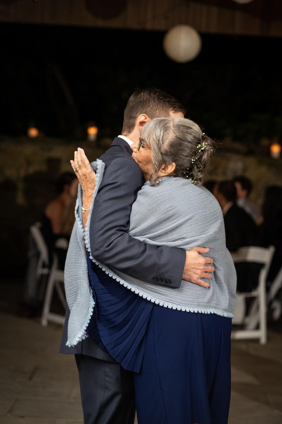 Cheryl Taylor Bagenstose embraces son Kyle Bagenstose during their mother-son dance at Kyle's wedding in October 2021, about four months before her diagnosis with CUP cancer.