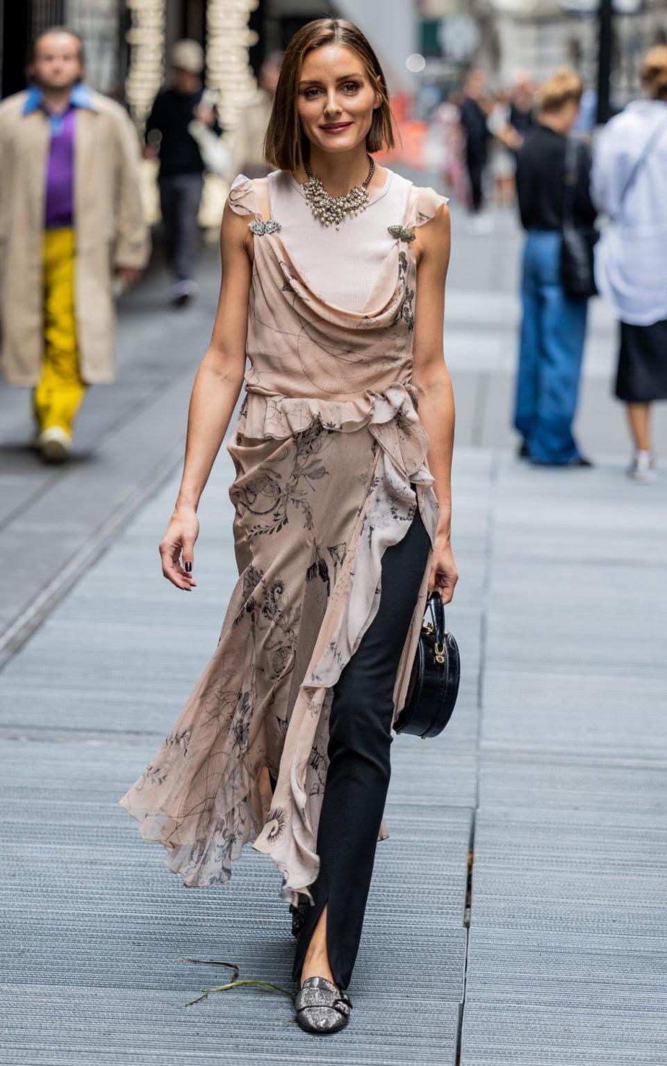 Olivia Palermo wears a dress over trousers in September, New York City