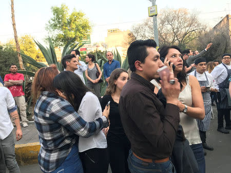 People stand on the street after an earthquake shook buildings in Mexico City, Mexico February 16, 2018. REUTERS/Claudia Daut