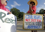 <p>Two protesters confer during a rally opposing the nomination of Judge Brett Kavanaugh to the U.S. Supreme Court, Tuesday, July 10, 2018, in Jackson, Miss. Planned Parenthood organizations rallied nationwide to protest the nomination of Kavanaugh. Abortion rights advocates fear the shutting down of the state’s only abortion clinic should Kavanaugh get seated on the bench. (Photo: Rogelio V. Solis/AP) </p>