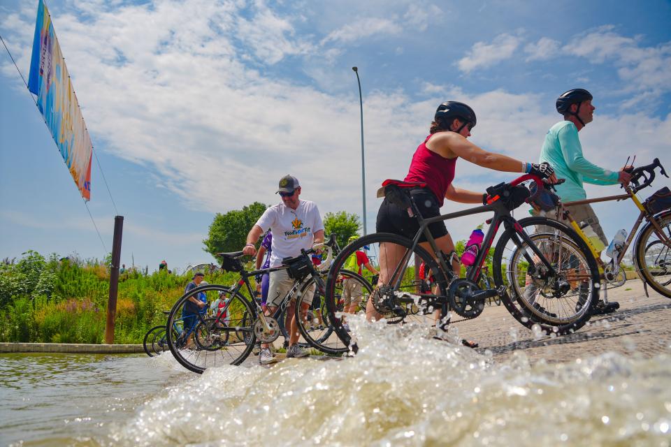 Riders dip their tires in the Missouri River to begin RAGBRAI 50 in Sioux City, Saturday, July 22, 2023.