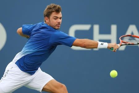 Sep 9, 2015; New York, NY, USA; Stan Wawrinka of Switzerland returns a shot to Kevin Anderson of South Africa on day ten of the 2015 U.S. Open tennis tournament at USTA Billie Jean King National Tennis Center. Mandatory Credit: Jerry Lai-USA TODAY Sports