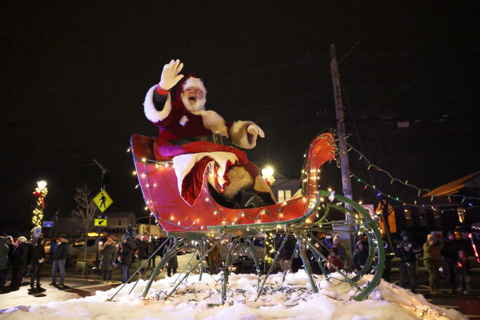 Santa waves to spectators from atop a float at the Stoughton Holiday Parade of Lights on Saturday, Dec. 10, 2022.