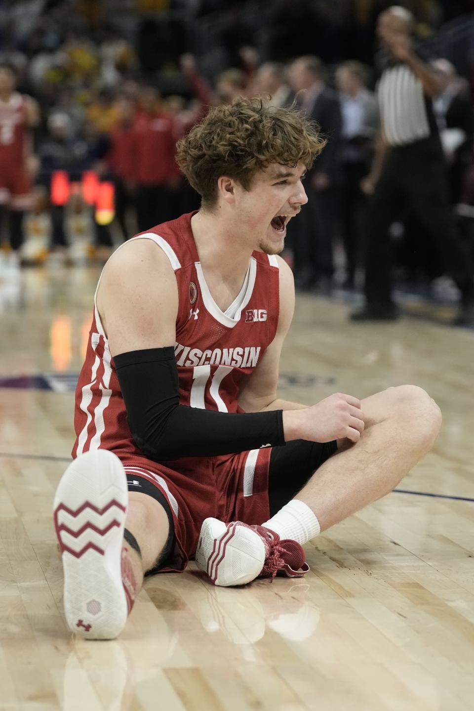 Wisconsin's Max Klesmit reacts after a foul in the final seconds of overtime of an NCAA college basketball game against Marquette Saturday, Dec. 3, 2022, in Milwaukee. Wisconsin won 80-77 in overtime. (AP Photo/Morry Gash)