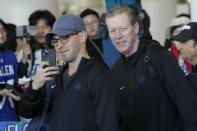 CORRECTS DATE - Former Los Angeles Dodgers pitcher and current broadcaster Orel Hershiser, right, and broadcast parter Joe Davis, left, walk through a terminal during the baseball team's arrival at Incheon International Airport, Friday, March 15, 2024, in Incheon, South Korea, ahead of the team's baseball series against the San Diego Padres. (AP Photo/Lee Jin-man)