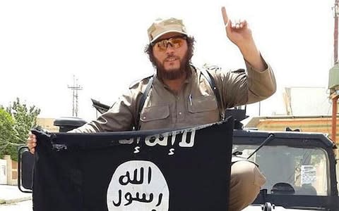 Khaled Sharrouf, an Australian-Lebanese national, holds the Isil flag while fighting in Syria