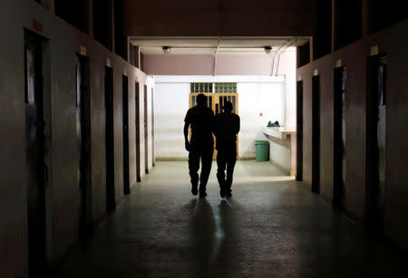 Joel Nganga is escorted into the police cells at the Mililani Law Courts where he appeared as a suspect in connection with the attack at the DusitD2 complex, in Nairobi, Kenya January 18, 2019. REUTERS/Thomas Mukoya