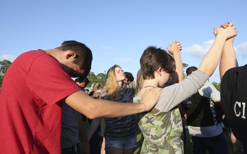 <p>Santa Fe High School students gather in prayer during a vigil following a shooting at Santa Fe High School in Santa Fe, Texas, on Friday, May 18, 2018. Seventeen-year-old Dimitrios Pagourtzis is charged with capital murder in the deadly shooting rampage. (Photo: Jennifer Reynolds/The Galveston County Daily News via AP) </p>