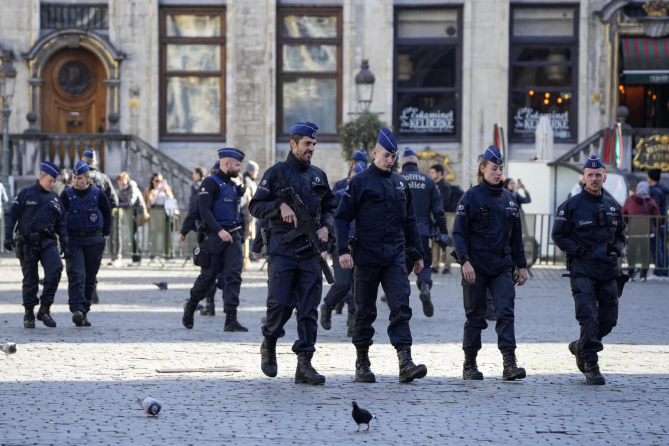 Belgian Police patrol the Grand Place in central Brussels, Tuesday, Oct. 17, 2023, following the shooting of two Swedish soccer fans who were shot by a suspected Tunisian extremist on Monday night. Police in Belgium have shot dead a suspected Tunisian extremist accused of killing two Swedish soccer fans in a brazen attack on a Brussels street before disappearing into the night on Monday. (AP Photo/Martin Meissner)