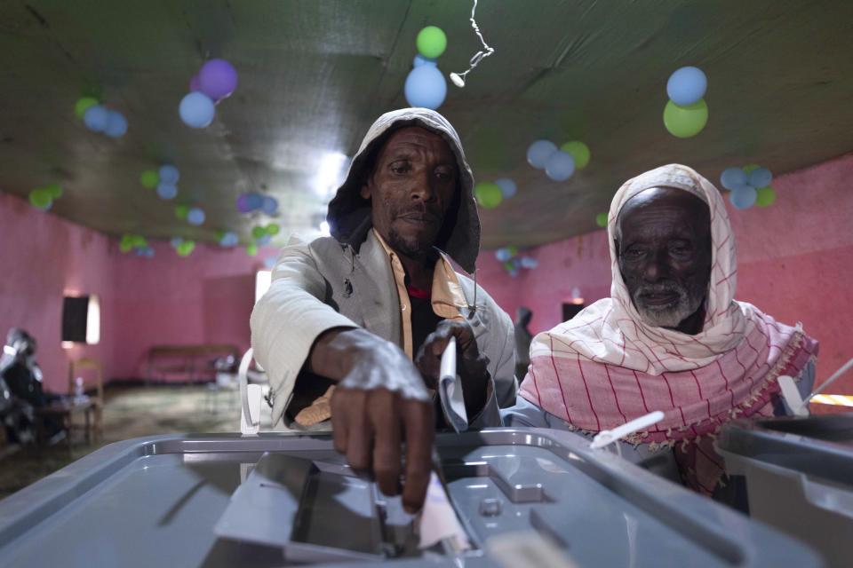 An Ethiopian man casts his vote in the general election, in Prime Minister Abiy Ahmed's home town of Beshasha, in the Oromia region of Ethiopia Monday, June 21, 2021. Ethiopia began voting Monday in the greatest electoral test yet for Prime Minister Abiy Ahmed as war and logistical issues meant ballots wouldn't be cast in more than 100 of the 547 constituencies across the country. (AP Photo/Mulugeta Ayene)