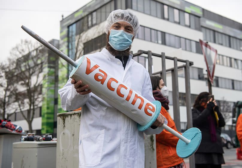 Activists demonstrate for the release of vaccine patents in front of the BioNTech headquarters in Mainz, Germany, December 13, 2021.