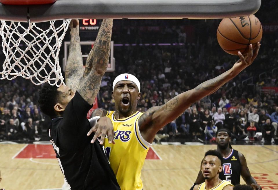 Los Angeles Lakers guard Kentavious Caldwell-Pope shoots as Los Angeles Clippers forward Wilson Chandler defends during the first half of an NBA basketball game Friday, April 5, 2019, in Los Angeles. (AP Photo/Mark J. Terrill)