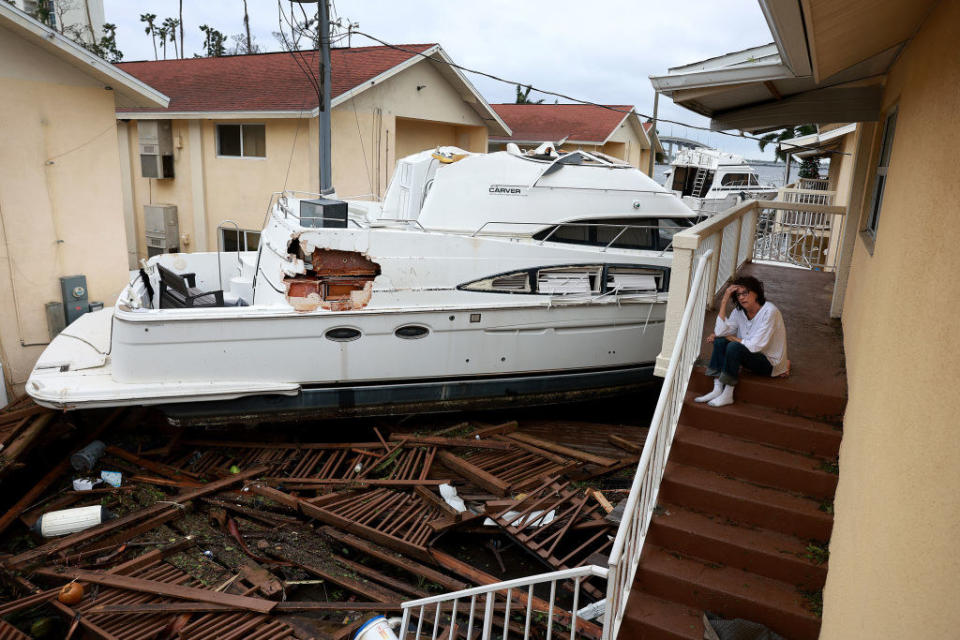 A boat washed up in between two rows of homes