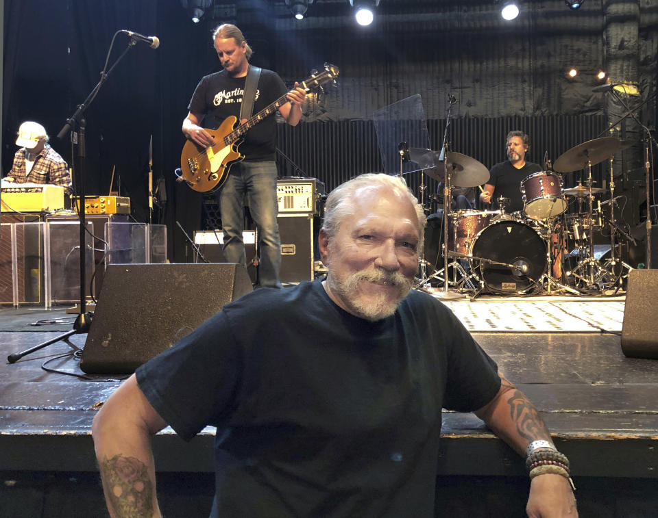 In this Thursday, Sept. 6, 2018 photo, Jorma Kaukonen, 77, poses for a photo as his Hot Tuna bandmates do a sound check before a gig at the El Rey Theatre in Los Angeles. Long before he wrote and recorded the Jefferson Airplane classic "Embryonic Journey," Kaukonen was on a decades-long journey of his own discovery. It began as a globe-circling embassy brat in the 1950s, continued as a psychedelic rock star in the '60s and shows no signs of slowing as the youthful co-founder Hot Tuna guitarist is still recording and touring. He stops long enough to recount much of it in his recent memoir "Been So Long: My Life & Music." (AP Photo/John Rogers)