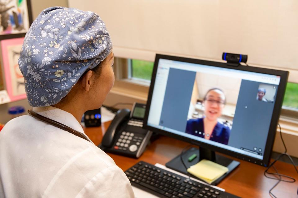 Dr. Elaine Zhai, a physician with RWJBarnabas Health Medical Group, conducts a telehealth visit with a patient from her office in Florham Park.