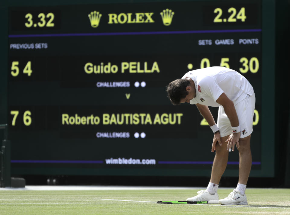 Argentina's Guido Pella is dejected after losing a point during a men's quarterfinal match against Spain's Roberto Bautista Agut on day nine of the Wimbledon Tennis Championships in London, Wednesday, July 10, 2019. (AP Photo/Ben Curtis)