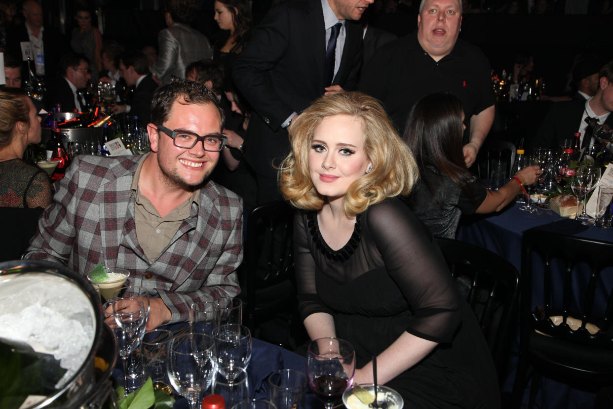 Alan Carr and Adele pose at tables during The BRIT Awards 2012  at The O2, on February 21, 2012 in London, England. (Photo by JM Enternational/Redferns)