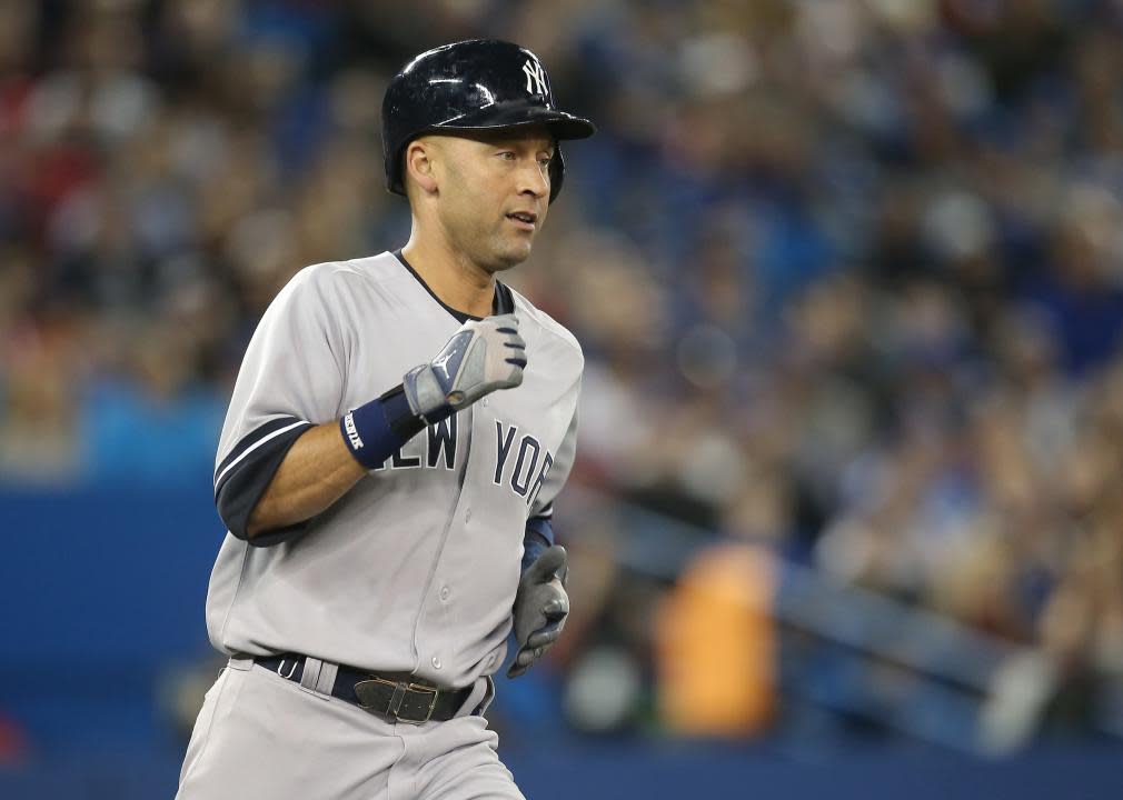 Derek Jeter #2 of the New York Yankees runs to first base after hitting a single.