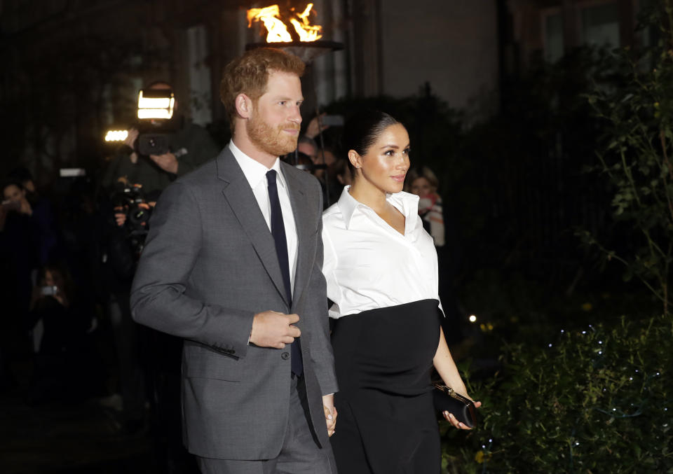 FILE - In this Thursday, Feb. 7, 2019 file photo, Britain's Prince Harry and Meghan, Duchess of Sussex arrive at the annual Endeavour Fund Awards in London. Prince Harry and his wife, Meghan, are fulfilling their last royal commitment Monday March 9, 2020 when they appear at the annual Commonwealth Service at Westminster Abbey. It is the last time they will be seen at work with the entire Windsor clan before they fly off into self-imposed exile in North America. (AP Photo/Kirsty Wigglesworth, file)