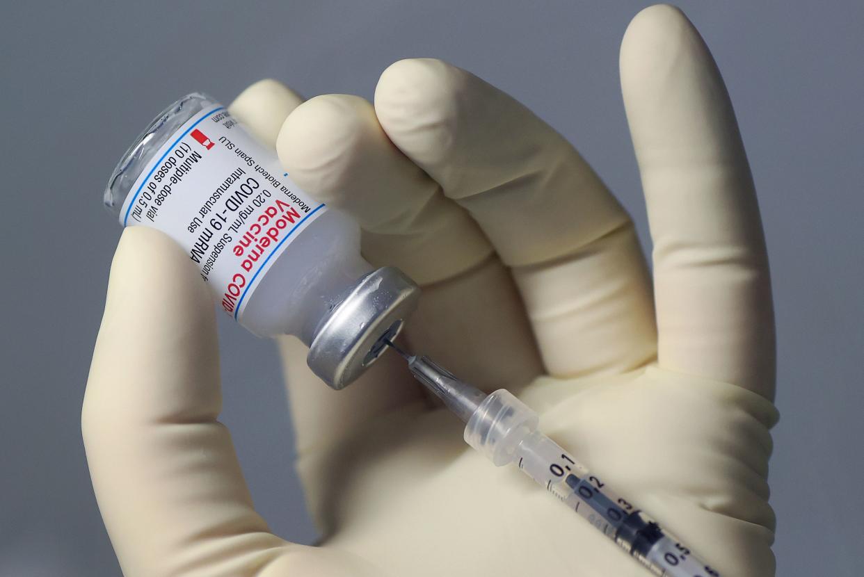 A pharmaceutical technician fills a syringe with the Moderna Covid-19 vaccine at the corona vaccination centre at the University hospital in Magdeburg, eastern Germany, on January 22, 2021. (Photo by Ronny Hartmann / AFP) (Photo by RONNY HARTMANN/AFP via Getty Images)