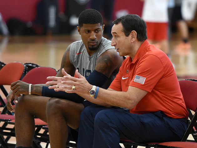 Paul George confers with Team USA coach Mike Krzyzewski. (Getty Images)