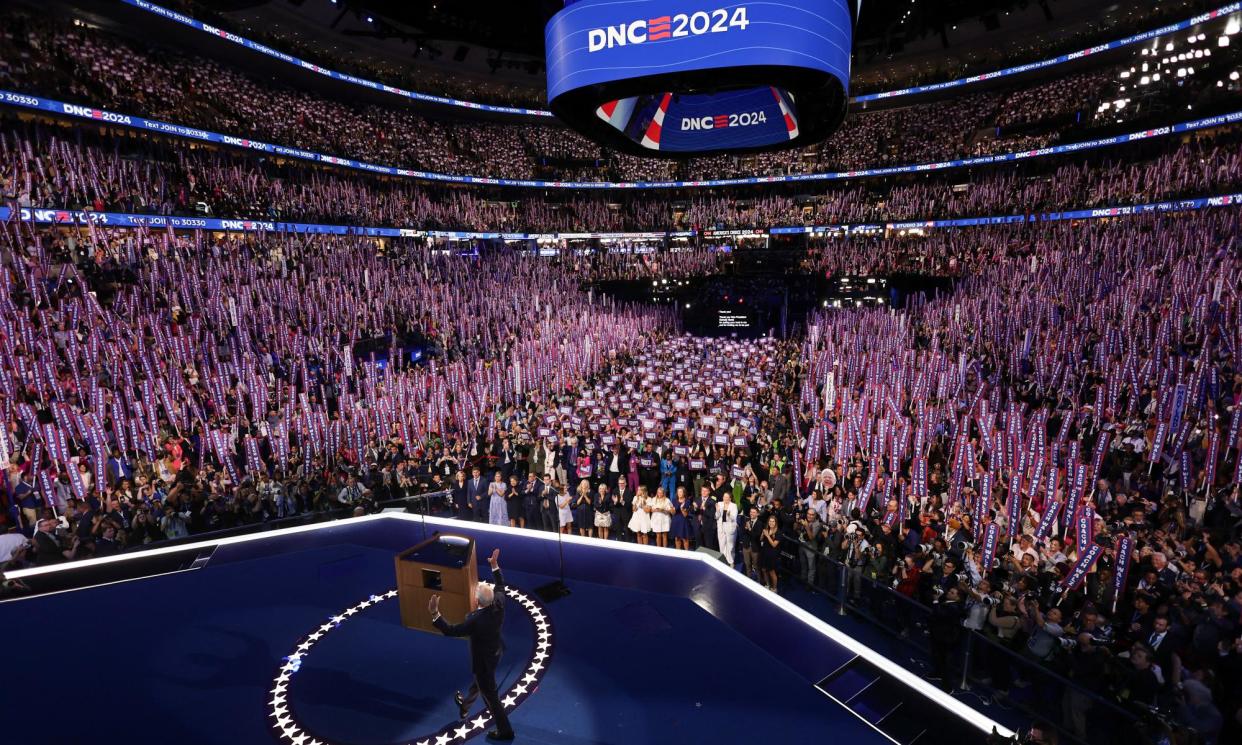 <span>Tim Walz takes the stage on the third day of the Democratic convention in Chicago, Illinois, on 21 August 2024.</span><span>Photograph: Mike Segar/AFP/Getty Images</span>