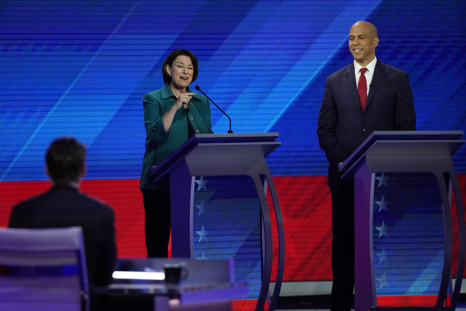 Sen. Amy Klobuchar, D-Minn., left, speaks as Sen. Cory Booker, D-N.J., right, listens Thursday, Sept. 12, 2019, during a Democratic presidential primary debate hosted by ABC at Texas Southern University in Houston. (AP Photo/David J. Phillip)