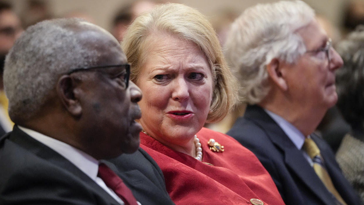 Associate Supreme Court Justice Clarence Thomas sits with his wife, Virginia Thomas, a conservative activist, at a meeting of the Heritage Foundation in 2021. 