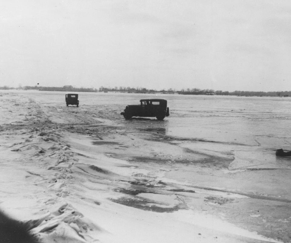 FILE - In this Feb. 14, 1930, file photo large quantities of Canadian beer and whisky are being transported in cars from Amherstburg, Ont., Canada, across the frozen lower Detroit River, to the Michigan side of the international boundary line. The cars are driven with one door open, so if the car goes through the ice the driver can scramble free. (AP Photo, File)