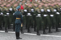 In this photo taken with long time exposure, Russian soldiers march toward Red Square during the Victory Day military parade in Moscow, Russia, Sunday, May 9, 2021, marking the 76th anniversary of the end of World War II in Europe. (AP Photo)