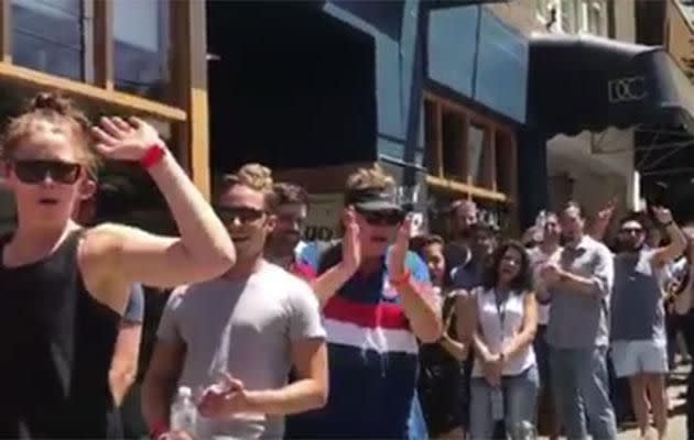 Waiters handed out free water and sunscreen for punters waiting in line. Photo: Twitter