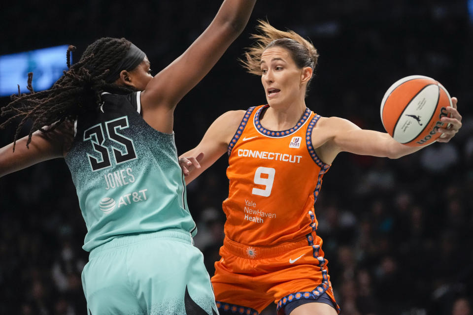 Connecticut Sun guard Rebecca Allen (9) moves the ball around New York Liberty forward Jonquel Jones (35) during the first half of Game 2 of a WNBA basketball playoffs semifinal Tuesday, Sept. 26, 2023, in New York. (AP Photo/Mary Altaffer)