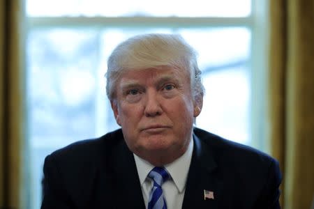 FIL PHOTO: U.S. President Donald Trump talks to journalists at the Oval Office of the White House after the AHCA health care bill was pulled before a vote in Washington, U.S. March 24, 2017. REUTERS/Carlos Barria/File Photo