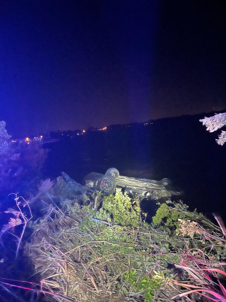 A Mercedes Benz rests upside down in the Caloosahatchee River off Business U.S. 41 in North Fort Myers. The luxury car swerved off 41 after it was involved in a crash with another car Sunday morning. The other car involved was a Lamborghini. The Florida Highway Patrol said the two cars had been traveling at a high rate of speed when the crash happened. Five people were injured in the crash.