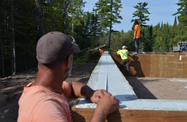 Construction workers are busy getting the foundations ready for a number of new housing units to be installed in Wauzhushk Onigum Nation, a First Nation with about 400 people living on reserve next to Kenora, Ont. There are longtime concerns over housing availability and affordability on Canadian First Nations that some say the federal parties haven't addressed. (Logan Turner/CBC - image credit)