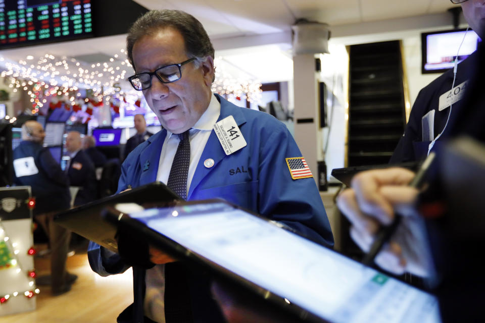 Trader Sal Suarino works on the floor of the New York Stock Exchange, Wednesday, Dec. 11, 2019. Stocks are opening mixed on Wall Street following news reports that US President Donald Trump might delay a tariff hike on Chinese goods set to go into effect this weekend. (AP Photo/Richard Drew)