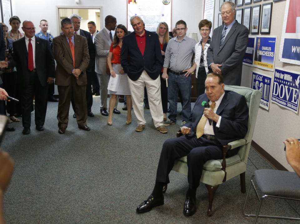 Former Sen. Bob Dole, R-Kan., talks to a crowd gathered at Johnson County Republican Headquarters in Overland Park, Kan., Monday, April 21, 2014. (AP Photo/Orlin Wagner)