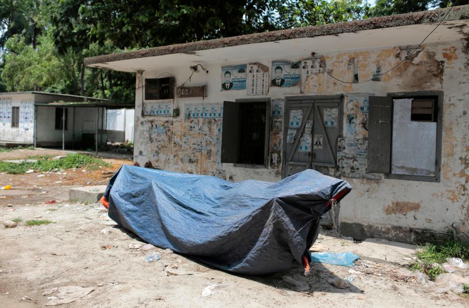 A lady Justice statue lies covered with a plastic sheet inside the Supreme Court premise in Dhaka, Bangladesh. - Credit: A M Ahad/AP