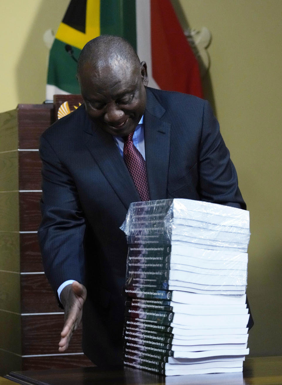 South Africa's President Cyril Ramaphosa receives the final report of a judicial investigation into corruption from Chief Justice Raymond Zondo at Union Building in Pretoria, South Africa, Wednesday, June 22, 2022.The probe has laid bare the rampant corruption in government and state-owned companies during former President Jacob Zuma’s tenure from 2009 to 2018. (AP Photo/Themba Hadebe)