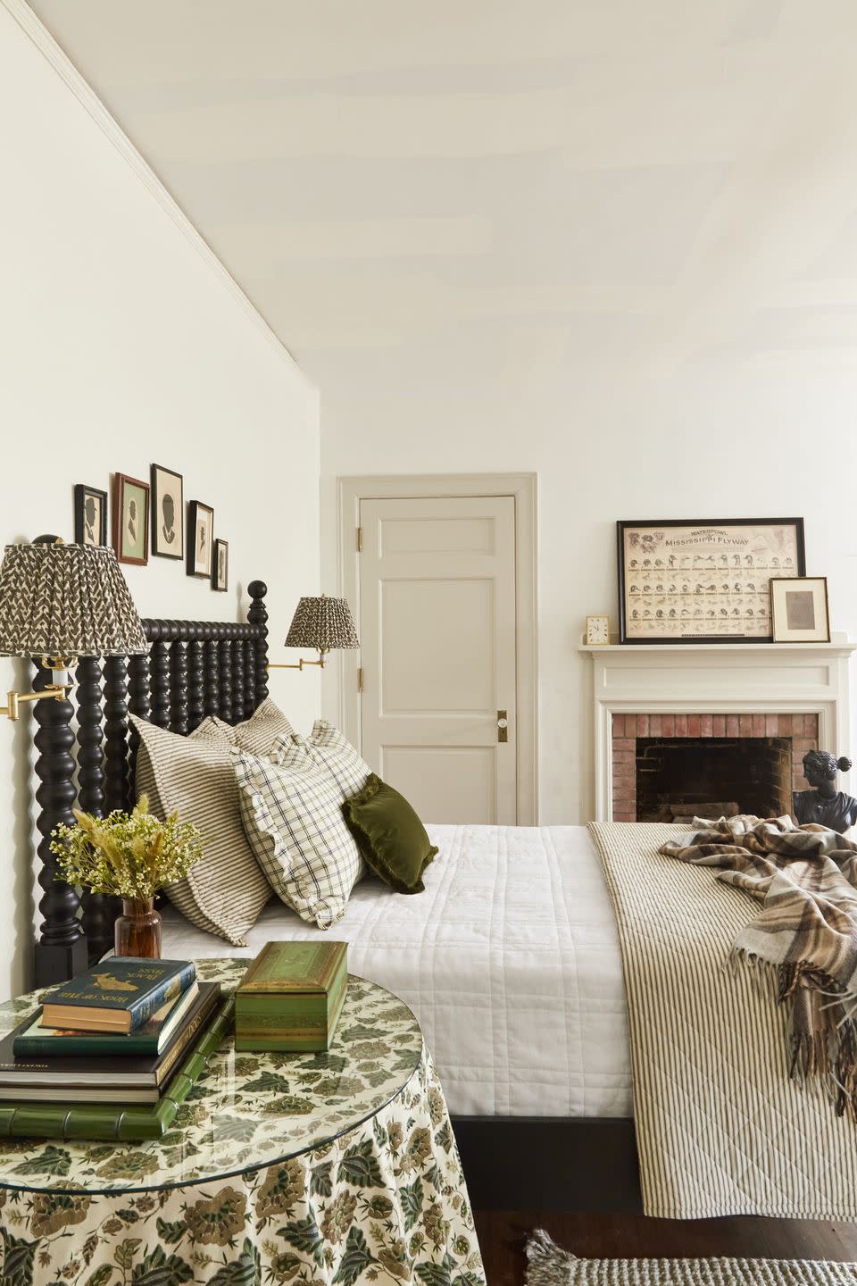 white farmhouse bedroom with black jenny lind bed and green accents